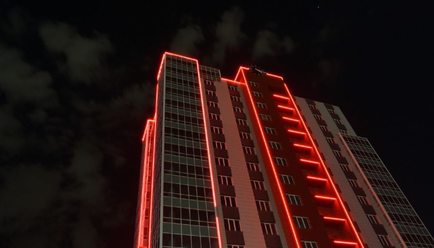 Building in darkness, lit up in red light
