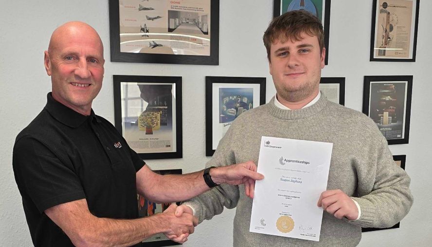 Ray Stephens and Louis Stephens in the office shaking hands