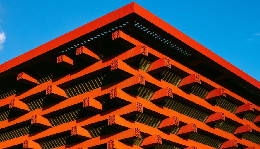 Top of structural, modern orange building