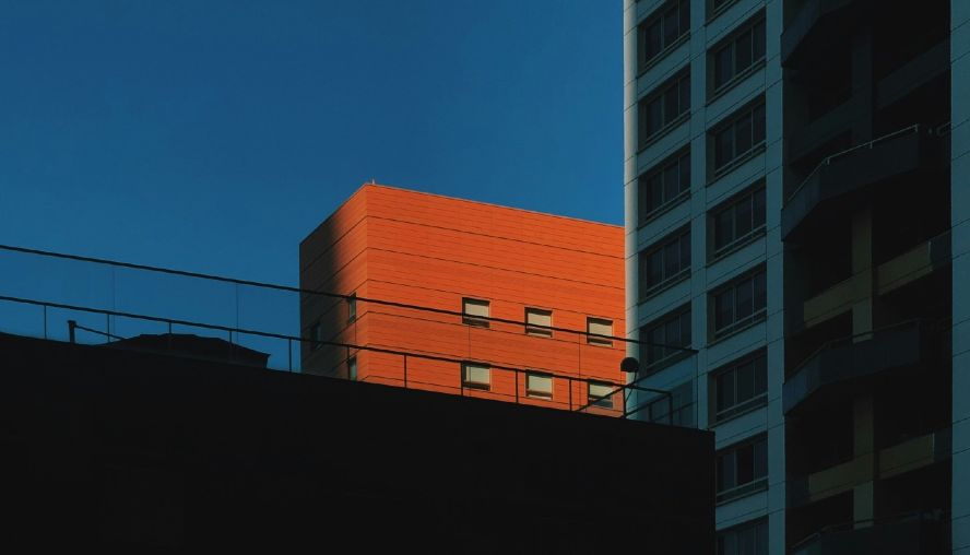 Orange building in shadows and strong sunshine