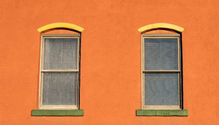 Looking up at the windows of an orange retail building