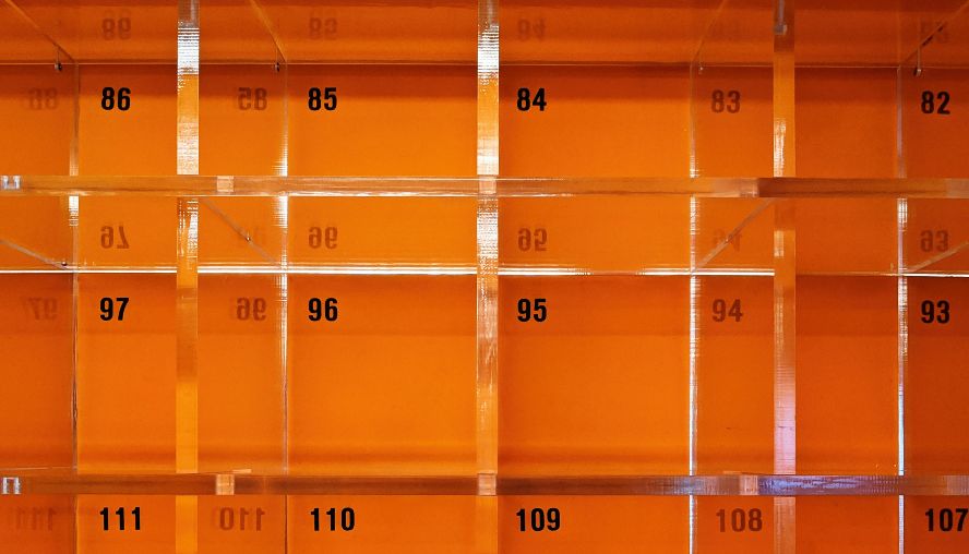 Two orange robots with glowing faces